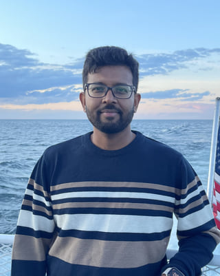 Saptarsi Mondal, photographed outdoors on a coastline at dusk.